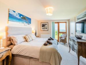a bedroom with a large bed and a television at Beachbreak - Uk42996 in Woolacombe +14 photos