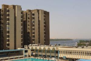 a view of two tall buildings and a swimming pool at فندق النادي in Aswan