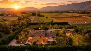 an aerial view of a house with the sunset in the background at Bed & Breakfast Le Piagge in Scurcola Marsicana