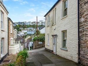 an alleyway between two buildings with a city in the background at Gypsett in Polruan