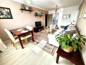 a living room with a table and a dining room at Samaria Central Apartment in Šamorín