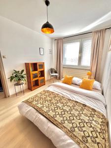 a bedroom with a large bed with yellow pillows at Samaria Central Apartment in Šamorín