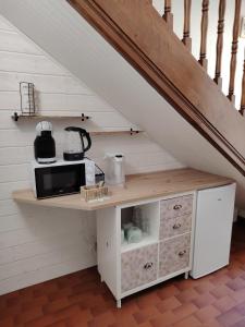 a kitchen with a counter with a microwave at L échappée verte in Gien