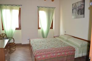A bed or beds in a room at Casa Rossana