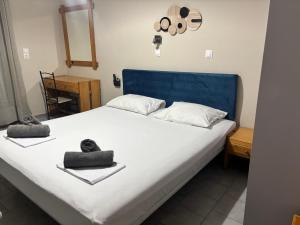 a bedroom with a bed with two towels on it at Aleka Apartments in Kos