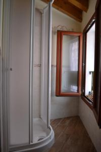 a shower with a glass door in a bathroom at Casa Rossana in Vasia