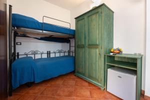 a bedroom with two bunk beds and a green cabinet at Bed and Breakfast San Domenico in Realmonte +54 photos