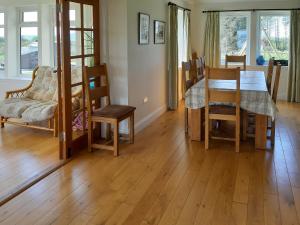 a kitchen and dining room with a table and chairs at Degnish Farmhouse - Swwu in Kilmelfort