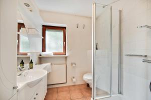 a bathroom with a shower and a sink and a toilet at Chiemsee Ferienwohnung Gartenblick in Prien am Chiemsee