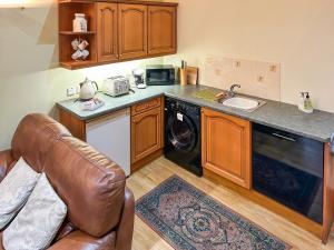a kitchen with a sink and a dishwasher at Ploughman's Rest - Uk51336 in Peebles