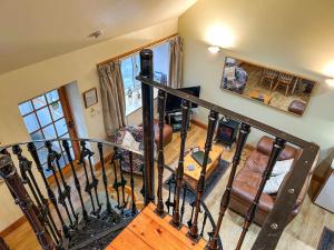 a spiral staircase in a living room with a stair case at Ploughman's Rest - Uk51336 in Peebles
