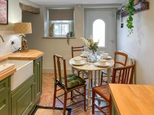 a kitchen and dining room with a table and chairs at River View in Lazonby +13 photos