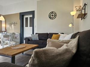 a living room with a couch and a table at Ferienhof Dahl in Wurster Nordseeküste