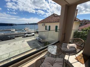 a balcony with chairs and a view of the water at Zenith Lux Apartment Beachfront & Parking in Bijela +13 photos