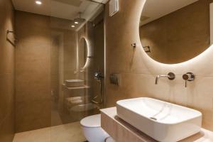 a bathroom with a sink and a toilet and a shower at EMERALD Luxury Living in Syvota +81 photos