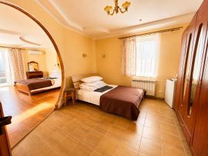 a bedroom with a bed and a mirror at Hotel Jasmin All Inclusive in Truskavets