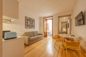 a living room with a couch and a table at Casa da Baixa by PURUS in Coimbra