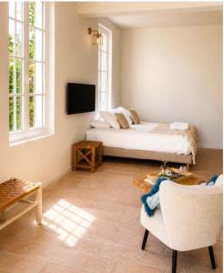 a bedroom with a bed and a couch and a tv at Domaine Robert in Rognes +46 photos