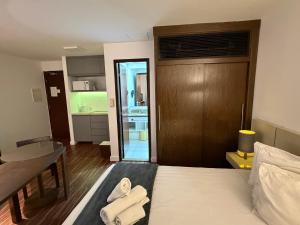 a living room with a bed and a kitchen at Hotel Alameda Campinas Paulista in São Paulo +12 photos