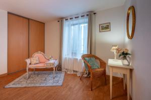 a room with a chair and a table and a window at La Marquise Duplex 2 Ch avec Terrasse et Climatisation in Socourt