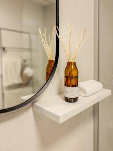 a mirror and a bottle on a shelf in a bathroom at LOEWENHERZ HOMES Mittenwald - Bijou in Mittenwald +19 photos