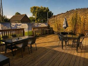 a patio with tables and chairs on a wooden deck at The Dolphin Hotel in Wincanton