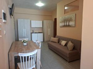 a living room with a couch and a table at Studio Lazaridi in Skala Rachoniou +20 photos