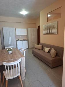 a living room with a couch and a table at Studio Lazaridi in Skala Rachoniou