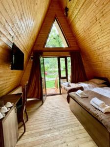 a attic room with two beds and a window at Royal Palace Hotel, Lagodekhi in Lagodekhi +113 photos