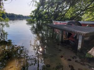 a boat sitting in a body of water at Ferienhaus Altes Kabinett in Schorssow