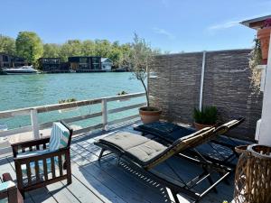a deck with a chair and a hammock on the water at Ada Gioia in Ulcinj