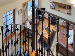 a room with a staircase with a couch and a table at Cosy Neuk - Uk51345 in Peebles +2 photos