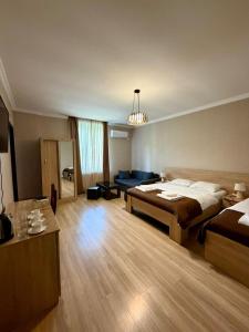 a large bedroom with a bed and a couch at Royal Palace Hotel, Lagodekhi in Lagodekhi