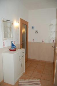 a bathroom with a white counter and a door at Ferienwohnung_Beethovenstrasse in Westerstede