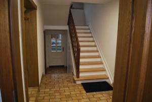 a hallway with a stairway with a door and a stair at Ferienwohnung Wennetal in Schmallenberg
