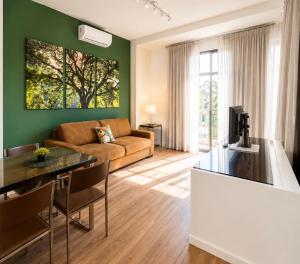 a living room with a couch and a table at Apartamento Vista Jardim in São Domingos