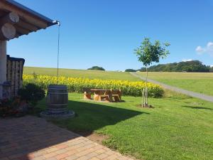 a park with a picnic table and a field of flowers at Steirer-Hof in Vöhl