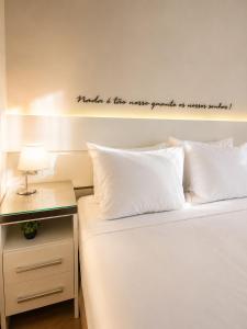 a bedroom with a bed with a sign on the wall at Apartamento Vista Jardim in São Domingos +19 photos