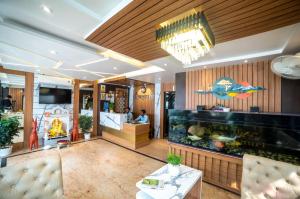 a lobby of a restaurant with a fish tank at Hotel Sonajhuri in New Digha