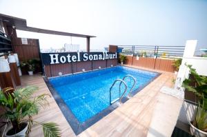 a swimming pool on the roof of a building at Hotel Sonajhuri in New Digha