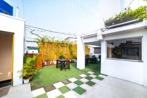 a patio with a table and chairs in a house at Hotel Sonajhuri in New Digha