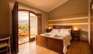 a bedroom with a bed and a large window at Bed & Breakfast Le Piagge in Scurcola Marsicana