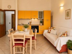 a kitchen and living room with a table and a couch at Luna House - Key to Villas in Valledoria