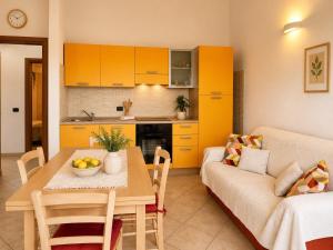 a living room with a table and a couch at Luna House - Key to Villas in Valledoria