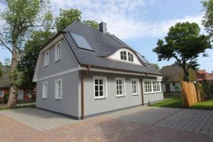 a large white house with a gambrel roof at Haus "Fock" in Prerow
