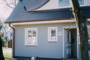 a gray house with white windows and a door at Haus "Fock" in Prerow