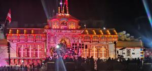 a large building lit up in red and white at Jai Shri Badri in Badrinath