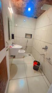 a bathroom with a white toilet and a sink at gulmarg peak view resort in Gulmarg +48 photos