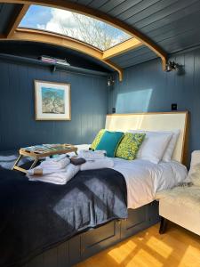 a bedroom with a large bed with a skylight at Da Vinci's Den in North Tawton