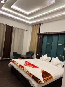a bedroom with a large bed with a blue headboard at gulmarg peak view resort in Gulmarg